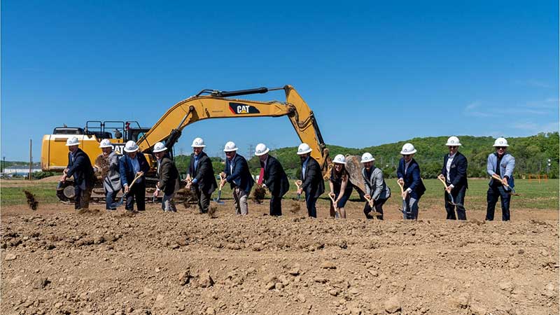 Group shovels dirt as part of groundbreaking ceremony